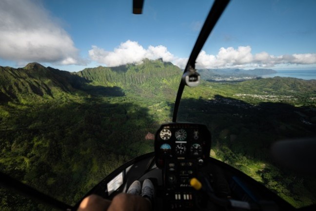 a close up of a traffic light with a mountain in the background
