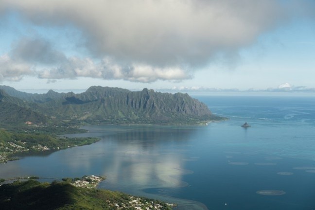 a body of water with a mountain in the background